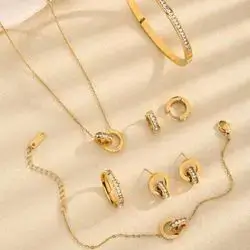 Set of earrings, bracelets, clusters, and rings decorated with rhinestones and embellished with a Roman numeral design.