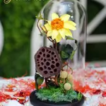 A glass bell containing a sunflower Forever
