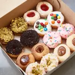 A box of mini donuts which contains 16 pcs of donuts with different flavors for kids.