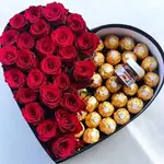 Heart-shaped box of roses and chocolate, in addition to a piece of Nutella