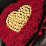 VIP BOX A large black heart-shaped box that includes a red rose and chocolate