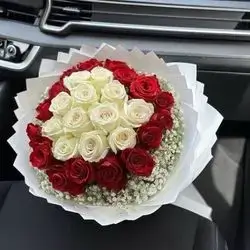 A Bouquet Of Red And White Roses And Accessories