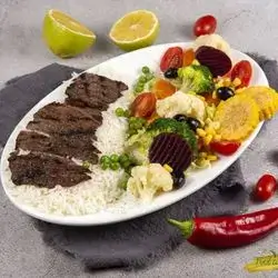 Lamb Steak With Rice, Steamed Vegetables, And Grilled Vegetables