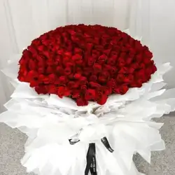 A Huge Bouquet Of Red Roses With White Packaging