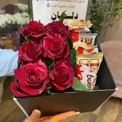 A Box Of Red Flowers And Sweets