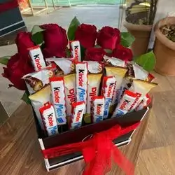 A Box Of Red Flowers And Sweets
