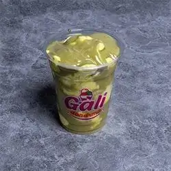 A Cup Of Pistachio Ice Cream And Pistachio Sauce