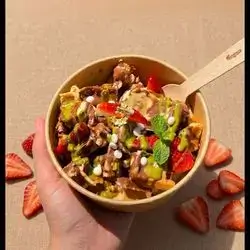 A tray filled with pancakes, strawberries, bananas, and Nutella
