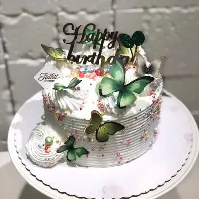 White cake with colorful butterflies